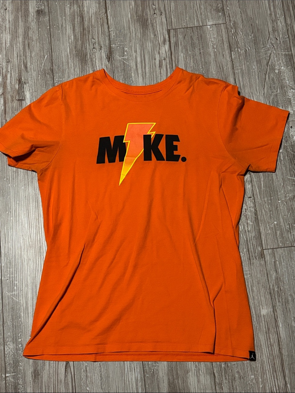 Jordan Orange Short‑Sleeve Tee with Black Logo and Yellow Lightning